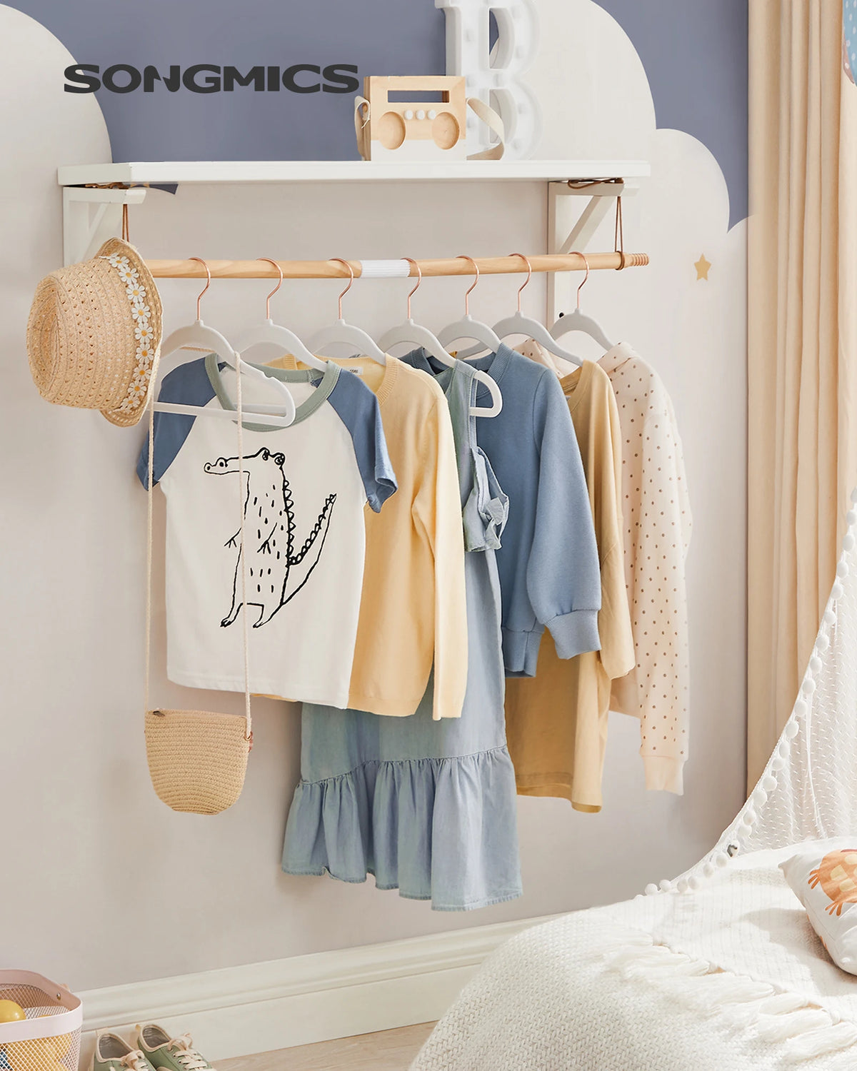 A display of kids' velvet hangers with 360° swivel hooks hanging various colored children's clothing on a white shelf.