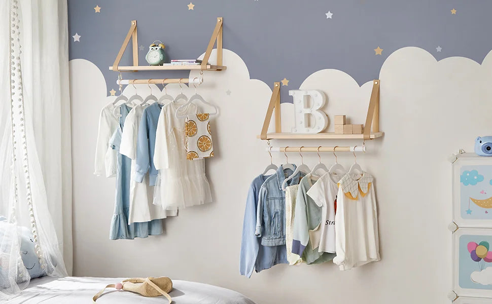 A display of wooden hangers and fabric clothing on a wall with a soft gray background.