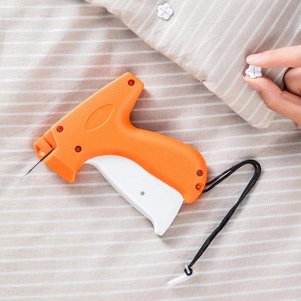 An orange and white handheld tagging gun rests on a striped fabric surface.