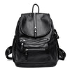 Black vintage faux leather women's backpack with multiple zippered compartments