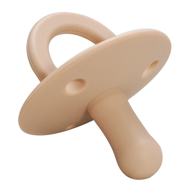 A beige silicone baby pacifier soother with a curved handle and a rounded body.