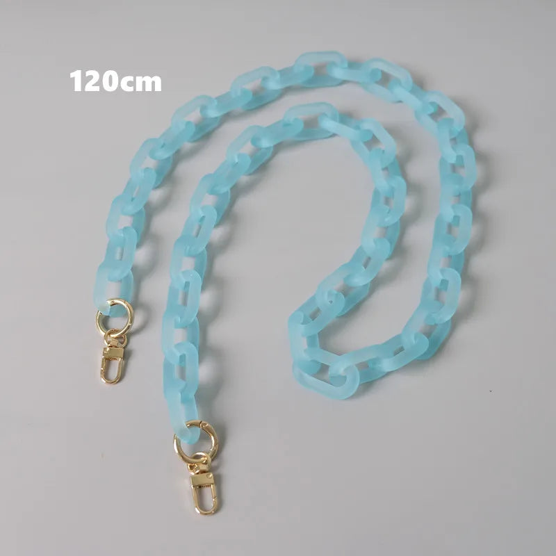 Helles blaues abnehmbares Kettengurtband für eine Tasche, auf einer grauen Fläche gelagert.