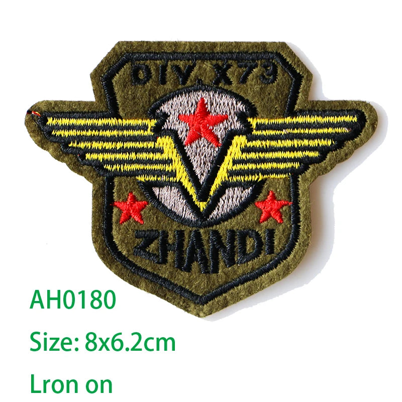 Embroidered US Marine Corps medal patch with yellow wings and red stars on a dark olive green fabric background