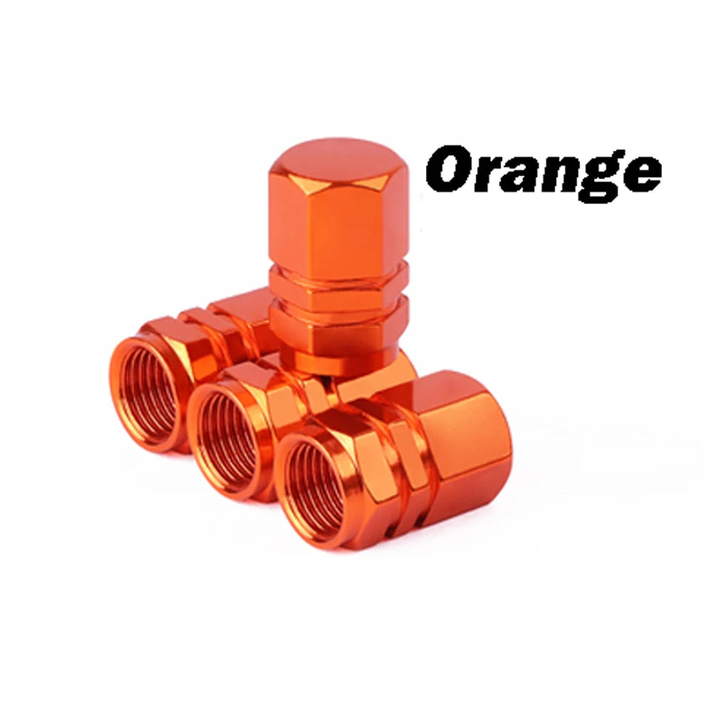 Orange durable aluminum tire valve caps shown in a close-up view.