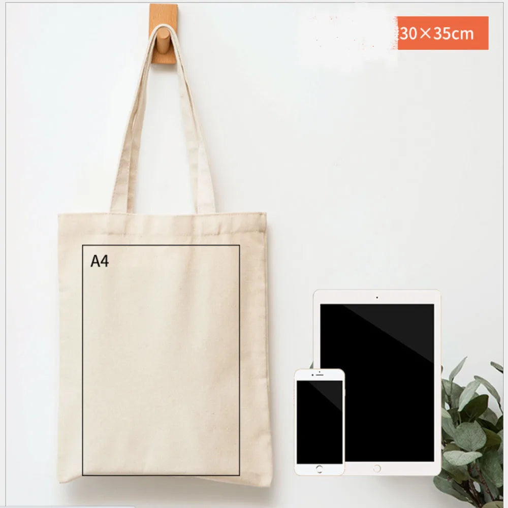 A beige canvas tote bag with an A4 sized insert is displayed next to a tablet and smartphone.