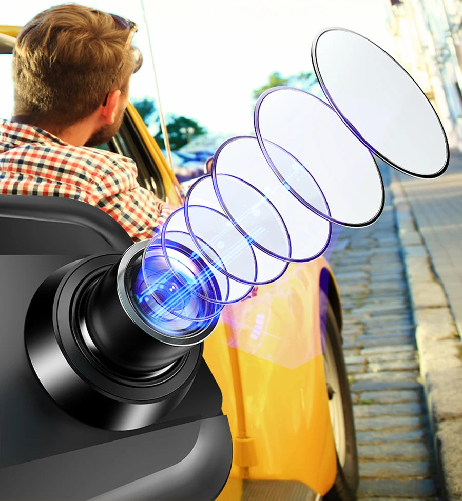 A close-up view of a dash cam camera mounted on a vehicle, showing multiple curved lenses and a blurred outdoor scene.