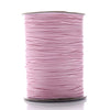 A spool of pink waxed cotton cord used for jewelry making