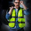 A man wearing a neon yellow high-visibility safety vest and glasses, looking intensely at the camera.
