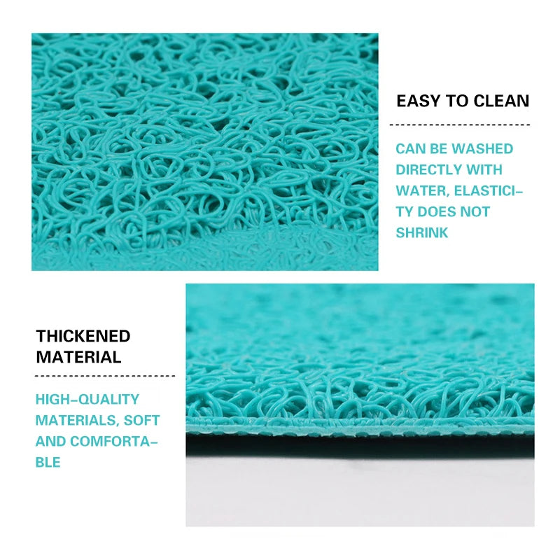 Close-up of a teal cat litter mat with a paw print design showing its mesh texture and thickness.