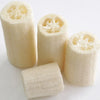 A set of six natural loofah scrubber sponges in light beige color, shown from the side.