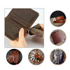 A set of brown leather tools including a wallet, stitching tool, and a leather pouch.