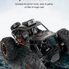 A black 1:18 RC off-road SUV with large tires and an HD FPV camera is shown on a rocky surface.