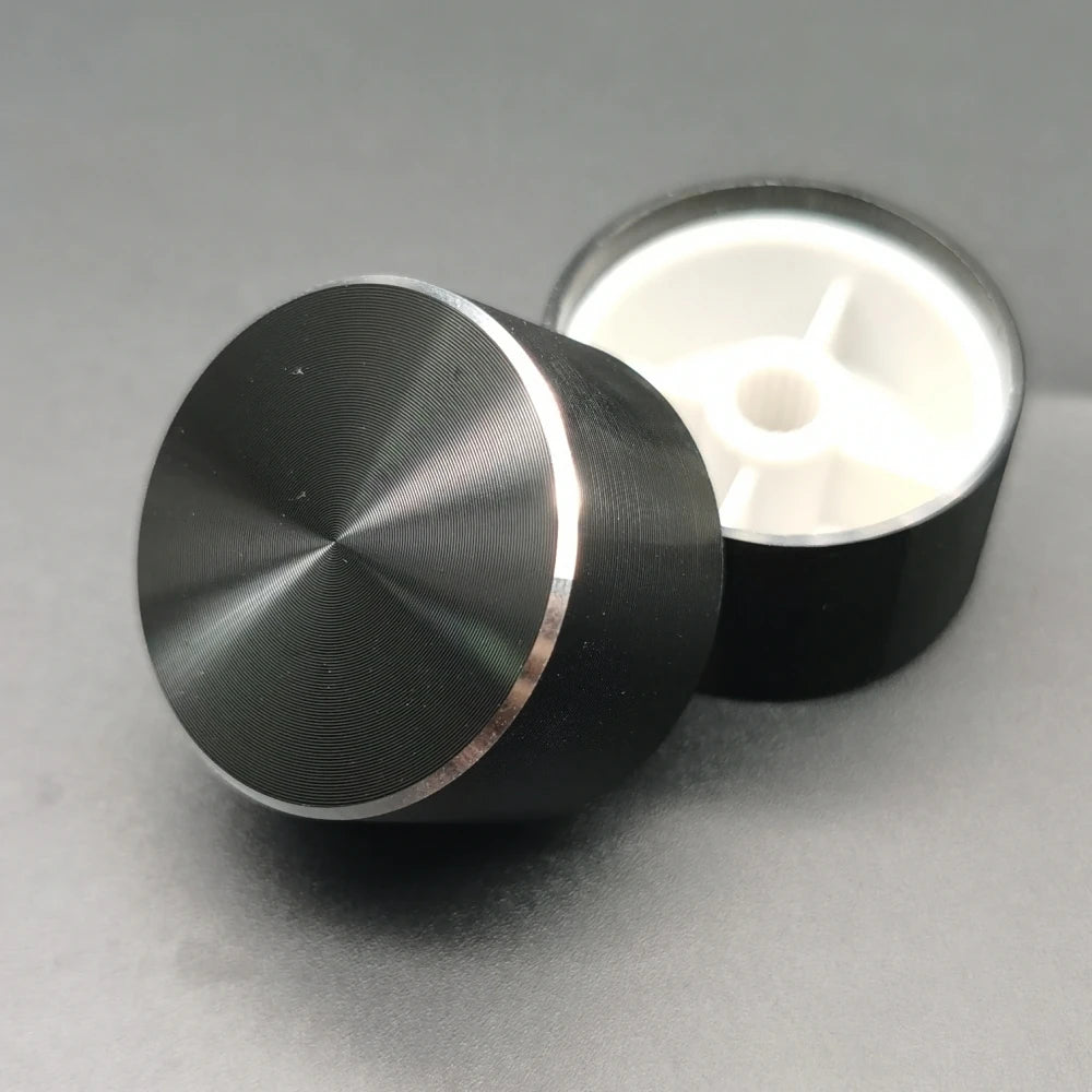 A black aluminum knob with a knurled finish is shown next to its white housing.