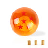 An orange, spherical gear shift knob with a star design is shown next to several metallic cylindrical components.