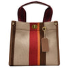 A beige canvas crossbody tote bag with brown and red stripes and a dark strap.