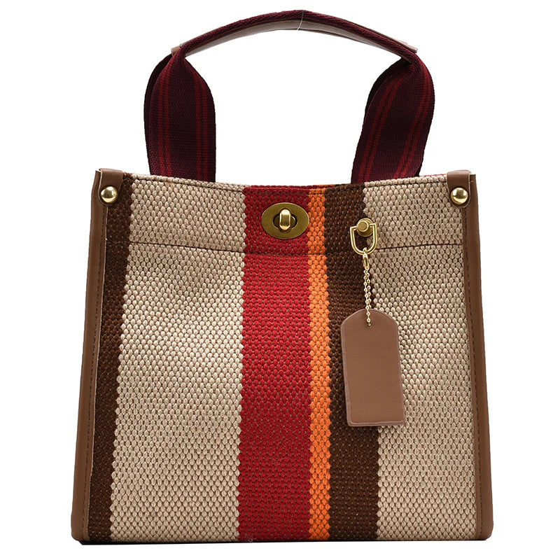 A beige canvas crossbody tote bag with brown and red stripes and a dark strap.