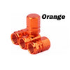 Orange durable aluminum tire valve caps shown in a close-up view.