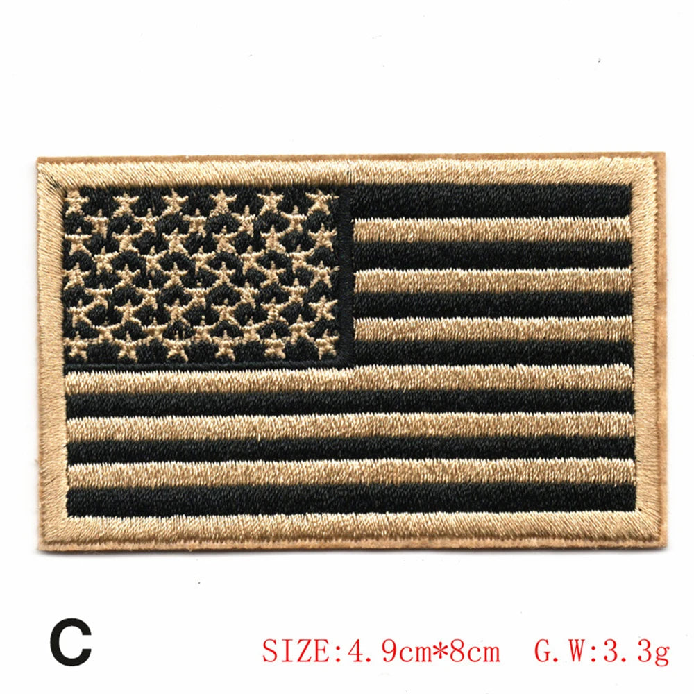 Embroidered American flag patch featuring stars and stripes in black and tan thread.