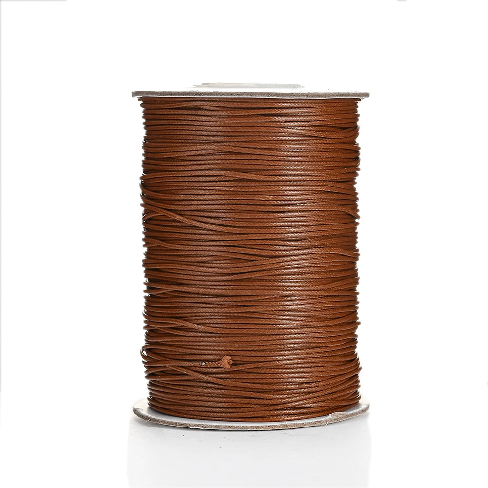 A spool of brown waxed cotton cord used for jewelry making