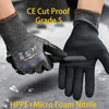 A hand wearing black cut-proof gloves is shown cutting a material with a knife.