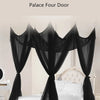 Black mosquito net bed canopy with four doors draped over a white bed frame.