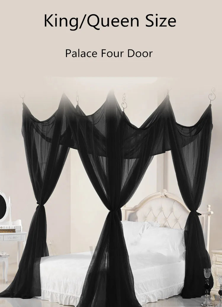Black mosquito net bed canopy with four doors draped over a white bed frame.