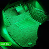Green ambient LED light illuminating a car interior with a keyboard and textured surfaces.