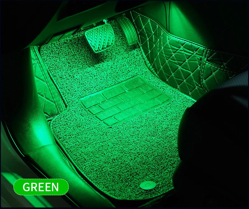 Green ambient LED light illuminating a car interior with a keyboard and textured surfaces.