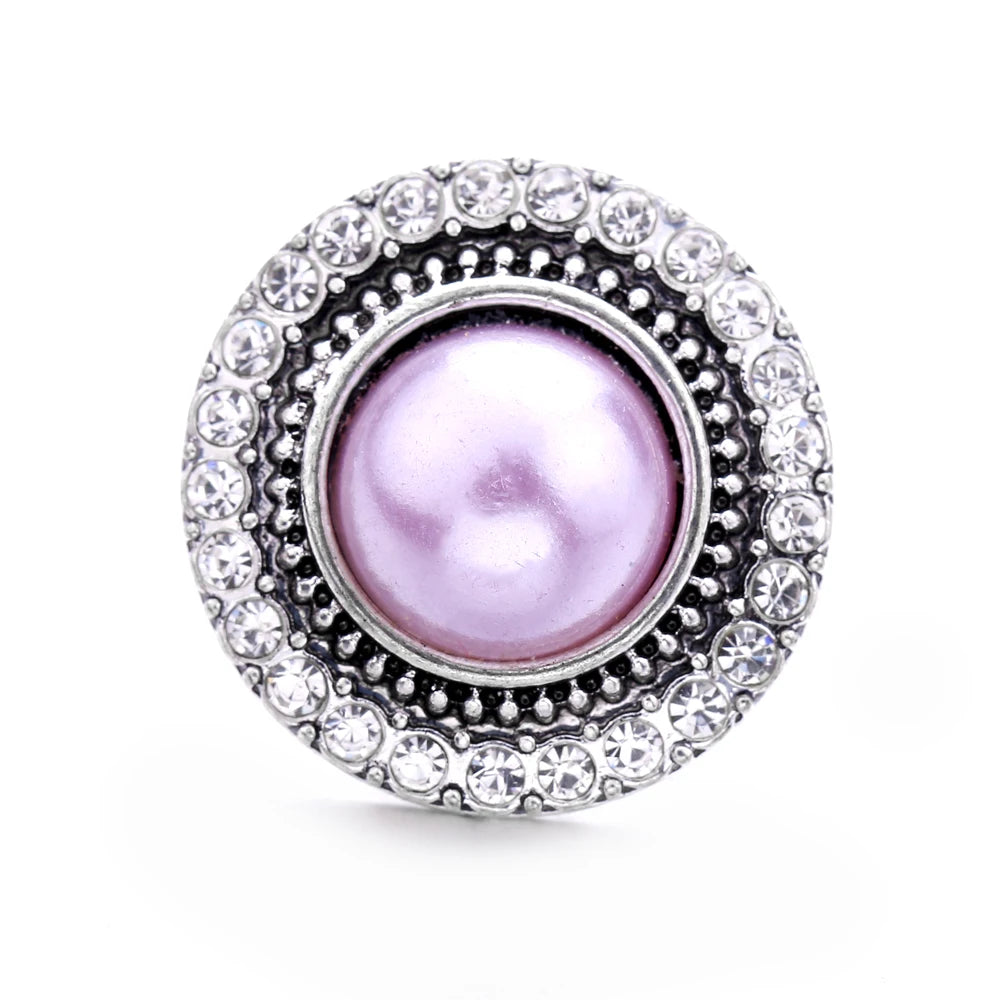 Round silver metal snap button with a purple pearl center surrounded by clear rhinestones