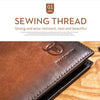 A close-up view of a brown genuine leather bifold wallet with visible stitching on a wooden surface.