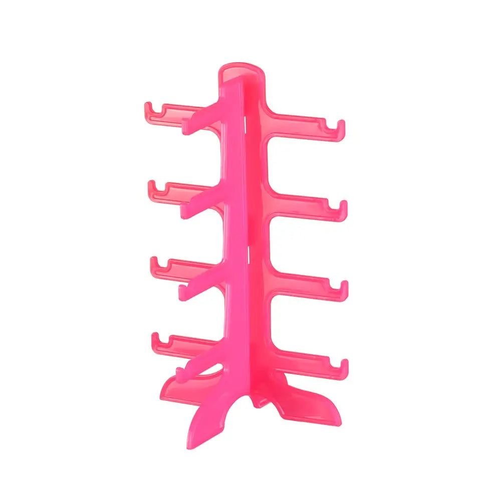 A pink plastic stackable display stand for holding sunglasses and reading glasses.