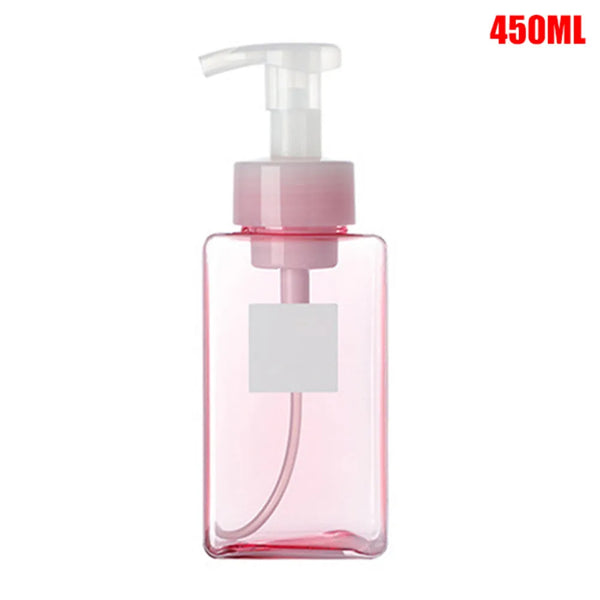 A pink portable manual foam soap dispenser bottle with a white pump top.