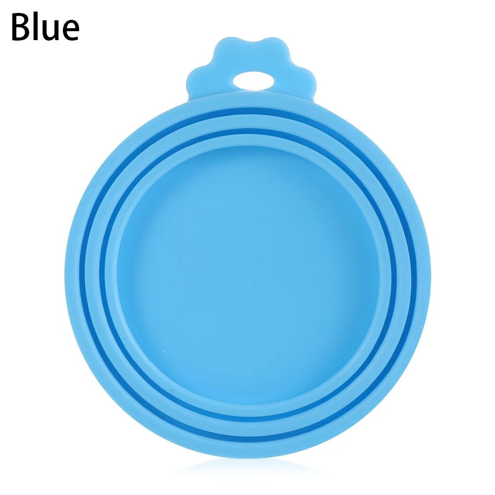 A light blue reusable silicone food storage lid with a handle, shown from above.
