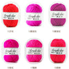 A collection of soft acrylic line yarn balls in various shades of pink and red, labeled by thread count.
