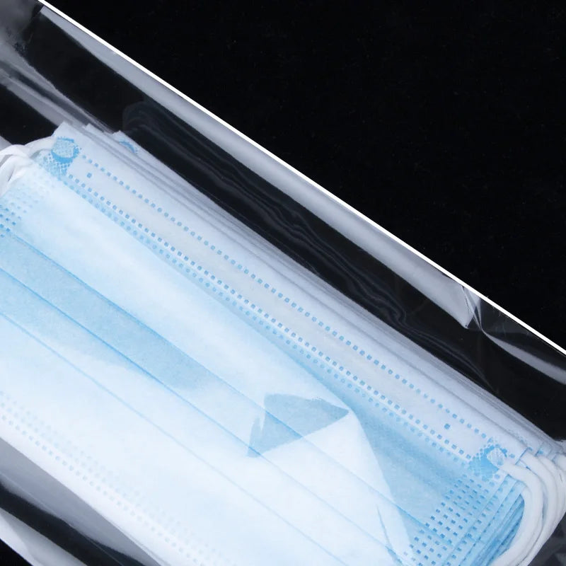 A clear self-adhesive resealable storage bag filled with light blue medical or protective sheeting.