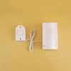 A white Montessori busy board kit with a power cord and mounting plate on a yellow background.