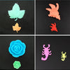 A collection of colorful, sculpted ocean animal toys including a green leaf, an orange leaf, a blue rose, a green rose, and a