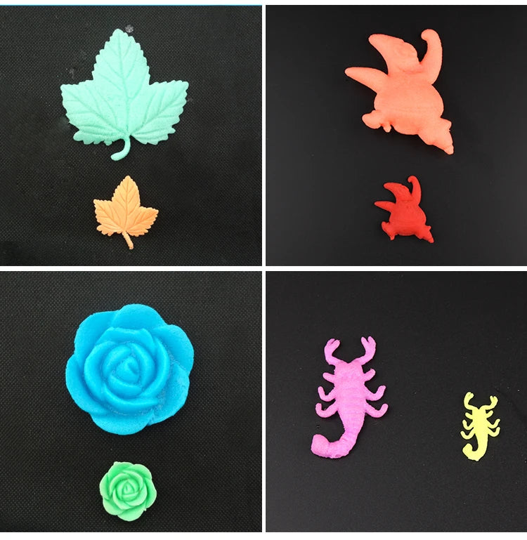 A collection of colorful, sculpted ocean animal toys including a green leaf, an orange leaf, a blue rose, a green rose, and a