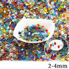 A pile of colorful decorative stone pebbles in various shades of red, blue, green, and yellow.