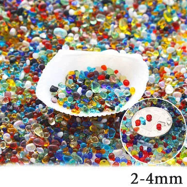 A pile of colorful decorative stone pebbles in various shades of red, blue, green, and yellow.