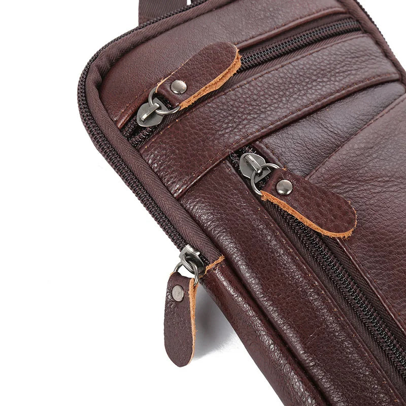 A close-up view of a dark brown vintage leather multi-pocket waist bag with zippered compartments.