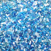 A close-up view of mixed glass seed beads in shades of blue and purple for jewelry making