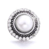 Silver metal snap buttons for jewelry making featuring a central white pearl surrounded by clear stones
