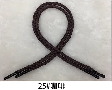A dark brown braided string rope shaped into an 'X' or cross pattern.