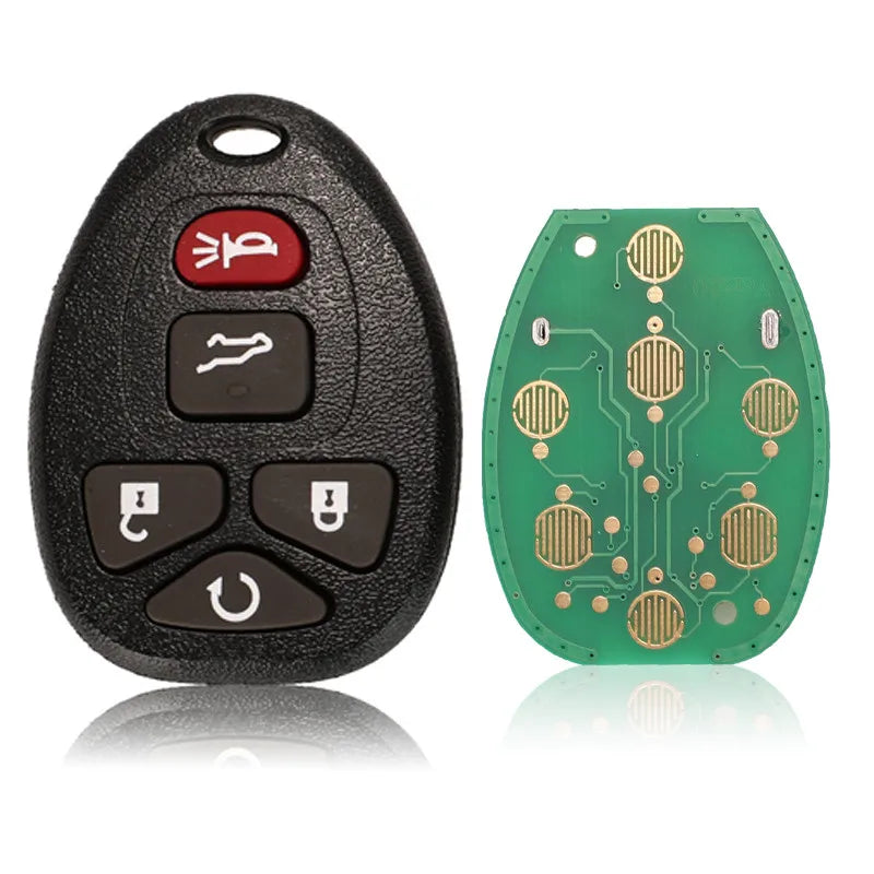 A black replacement car key fob with buttons and a green circuit board is shown.