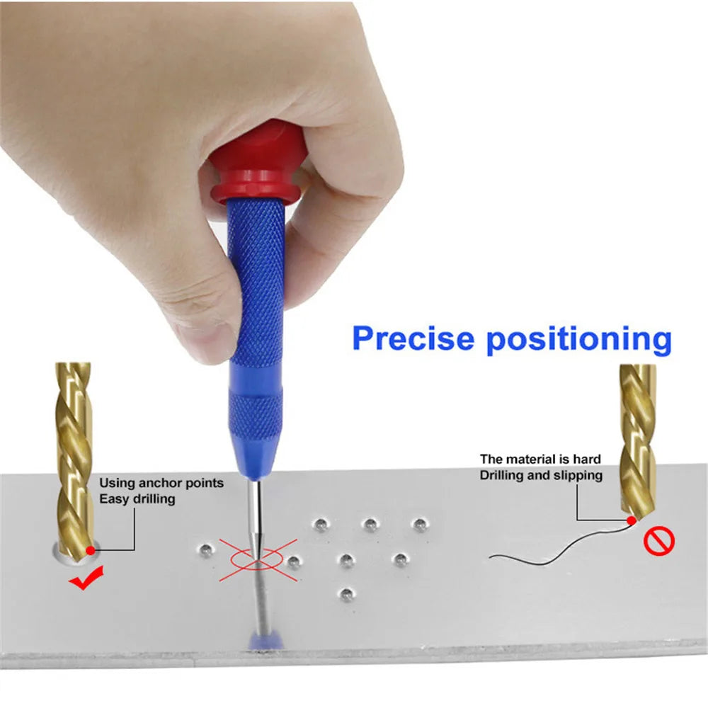 A hand holds a blue and red spring-loaded automatic center punch tool used for precise positioning on a metal surface.
