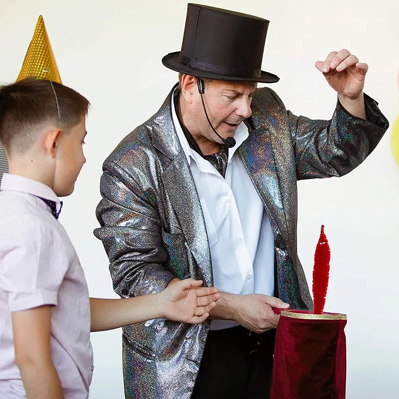 A magician in a sparkly jacket performs a trick with a magic bag and a red flower.