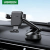 A black UGREEN gravity car phone holder with a suction mount is shown mounted on a dark surface.