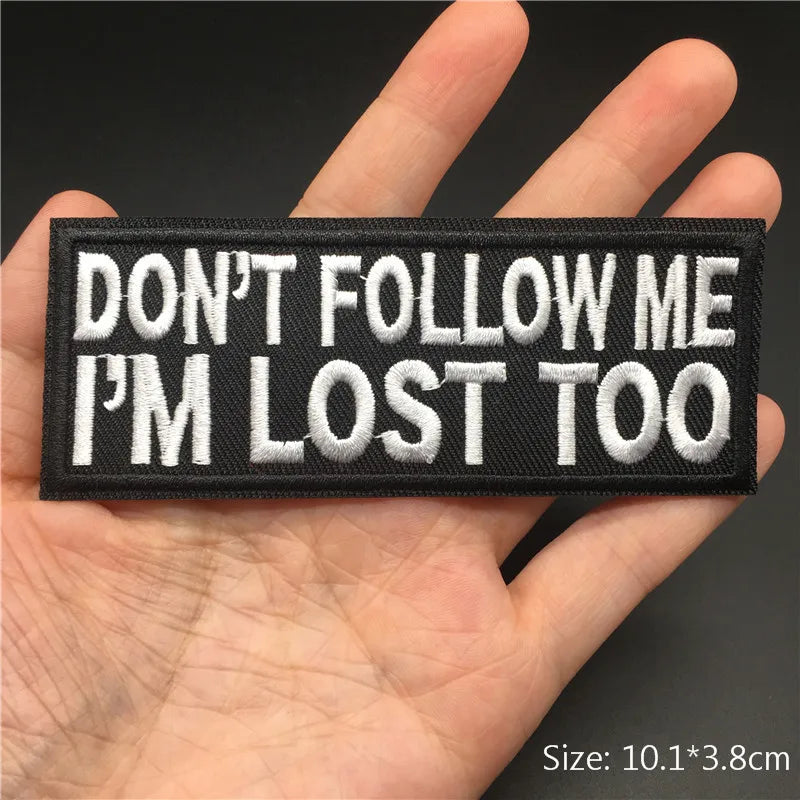 Black embroidered patch with white text that reads DON'T FOLLOW ME I'M LOST TOO