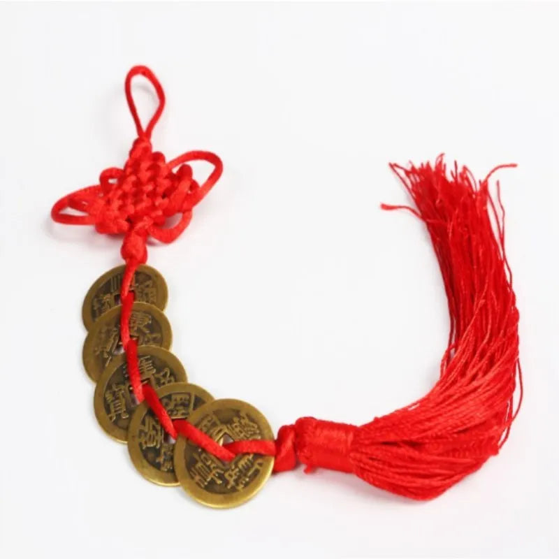 Chinese Feng Shui wealth coins strung together with a red handmade knot and tassel